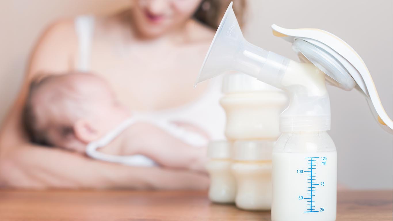 women feeding baby pumped milk