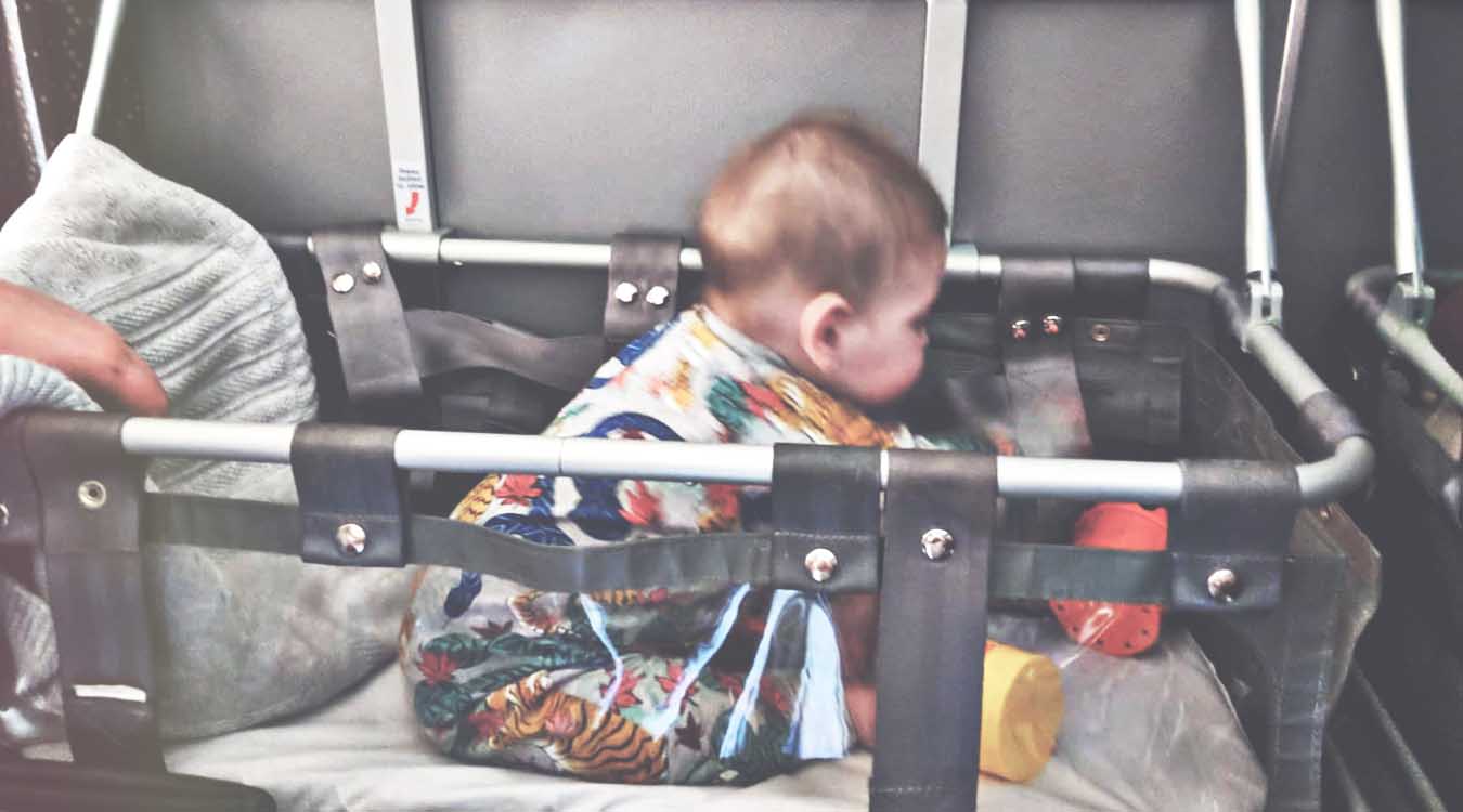 baby-playing-in-airplane-bassinet