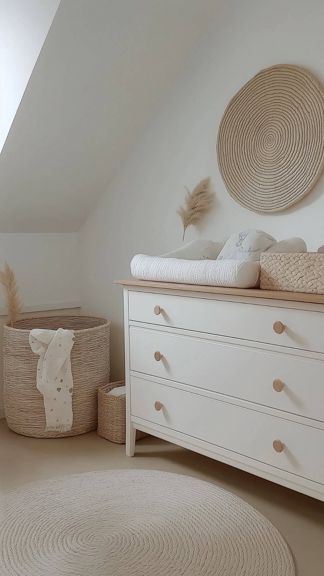 Minimalist neutral nursery with natural textures, soft whites, and wood accents creating a serene atmosphere.