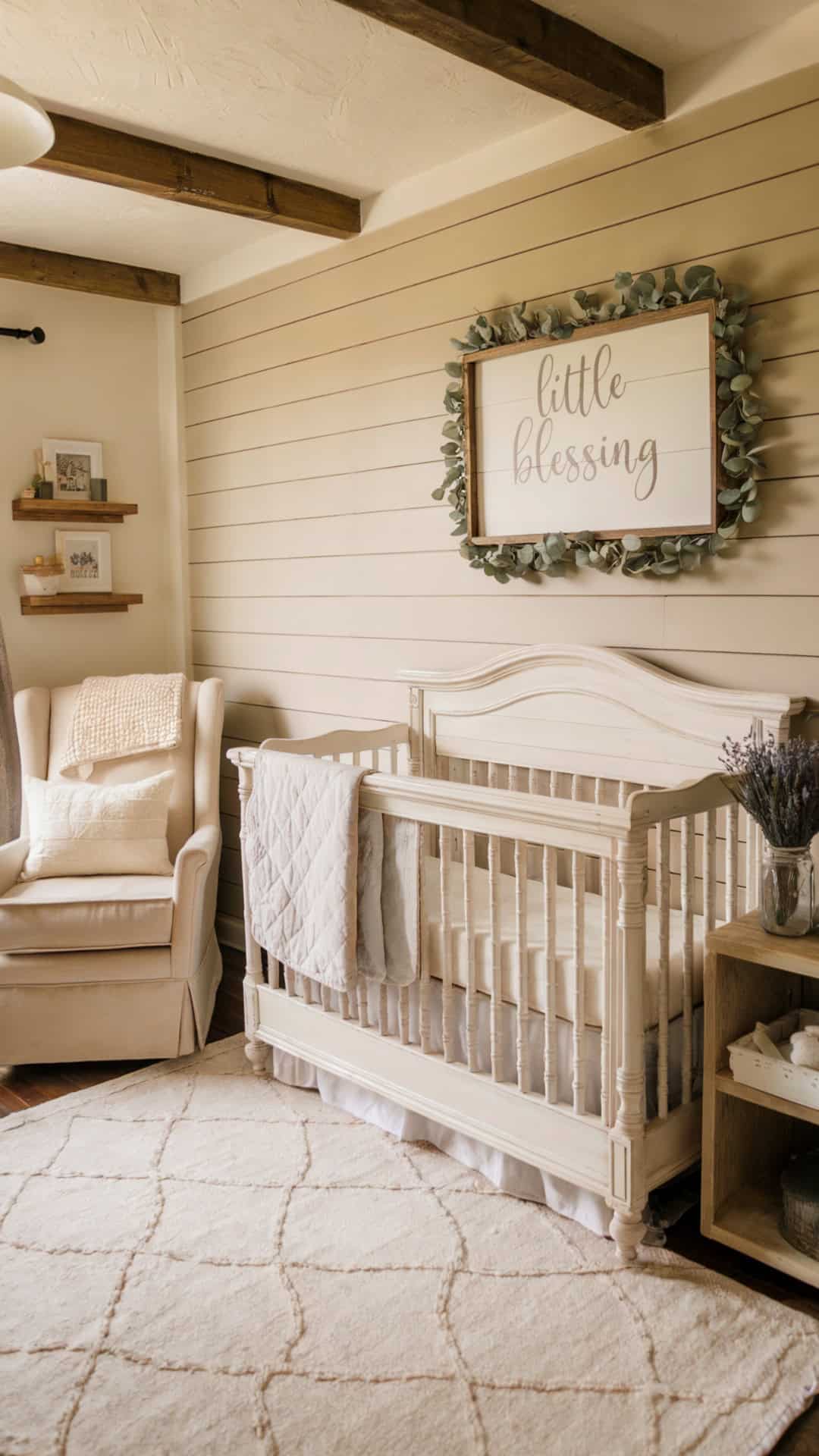 Farmhouse-style baby girl nursery with shiplap walls, a distressed wood crib, and "Little Blessing" wall sign surrounded by eucalyptus.