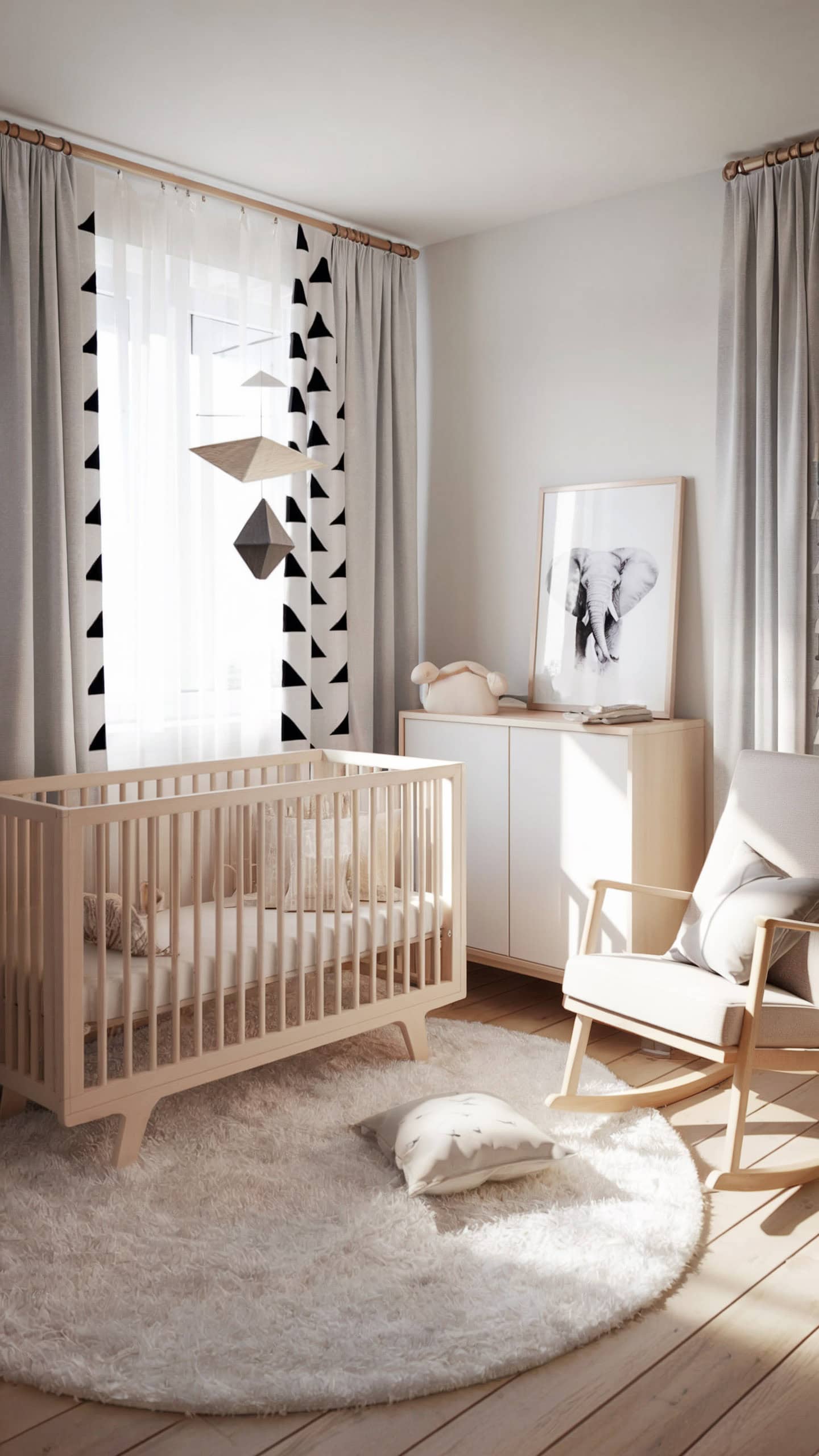 Modern minimalist baby girl nursery with wooden crib, geometric curtains, and elephant wall art.